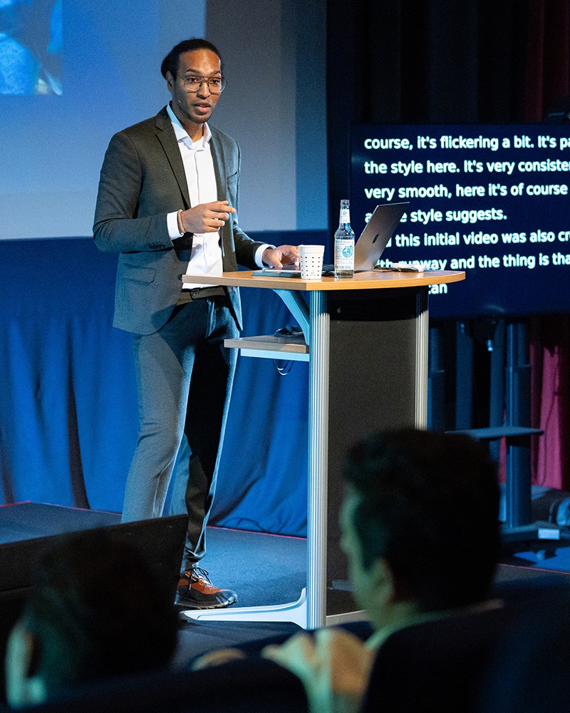 Jacques Alomo auf einer Bühne bei einer KI-Keynote